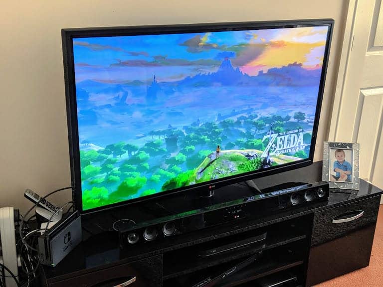A flat screen tv with a video game on the screen
