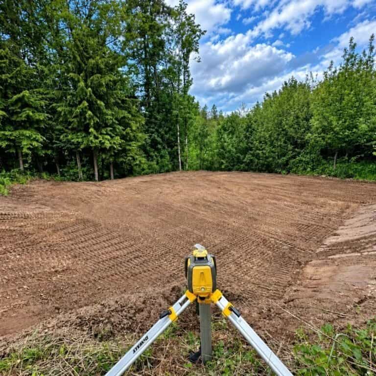 Open lot graded smooth with a laser receiver in the ground in Columbia City, Oregon
