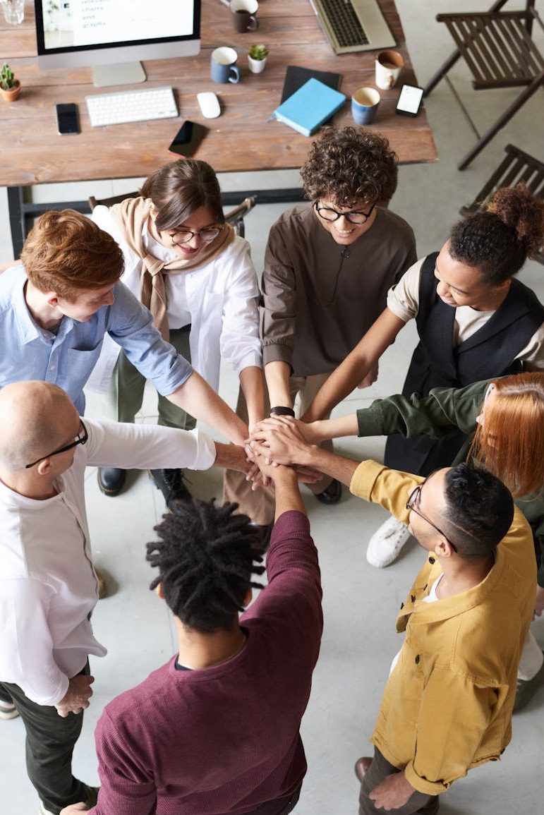 photo of people holding each other s hands