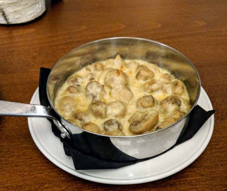 creamed mushrooms in a small silver coloured pan style dish