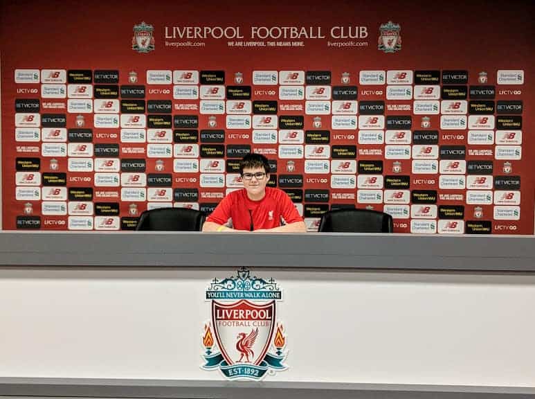 Liverpool F.C. interview of a child in front of media wall.
