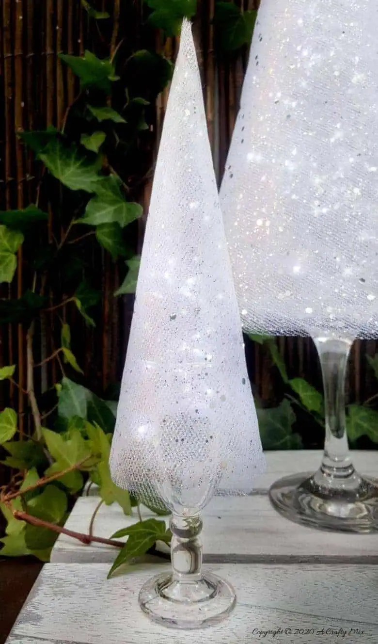 These budget-friendly wine glass Christmas trees are sure to brighten up your festive decor. #ChristmasDIY #ChristmasTree #ACraftyMix #ChristmasCrafts #TableDecor #WineGlassRepurpose