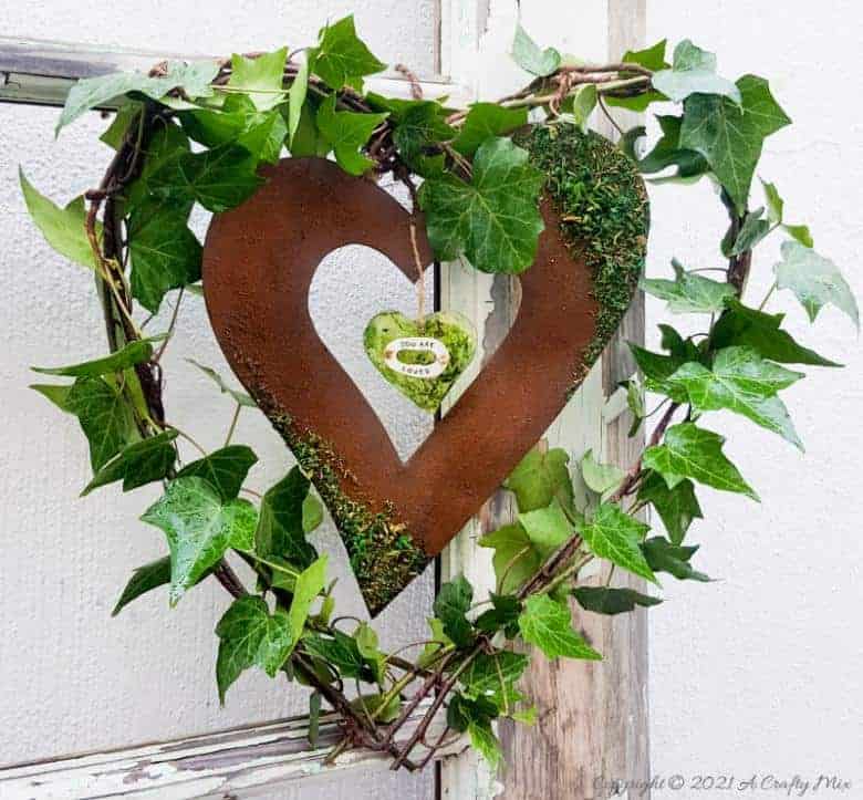 Celebrate the arrival of the most beautiful season of all and make this gorgeous Spring heart wreath. All that luscious greenery promises that the cold, miserable days of winter are almost over and that Spring is on her way, bursting with life and new growth. #SpringWreath #HeartWreath #ACraftyMix #DIYWreath #FreshIvy #ValentinesDay