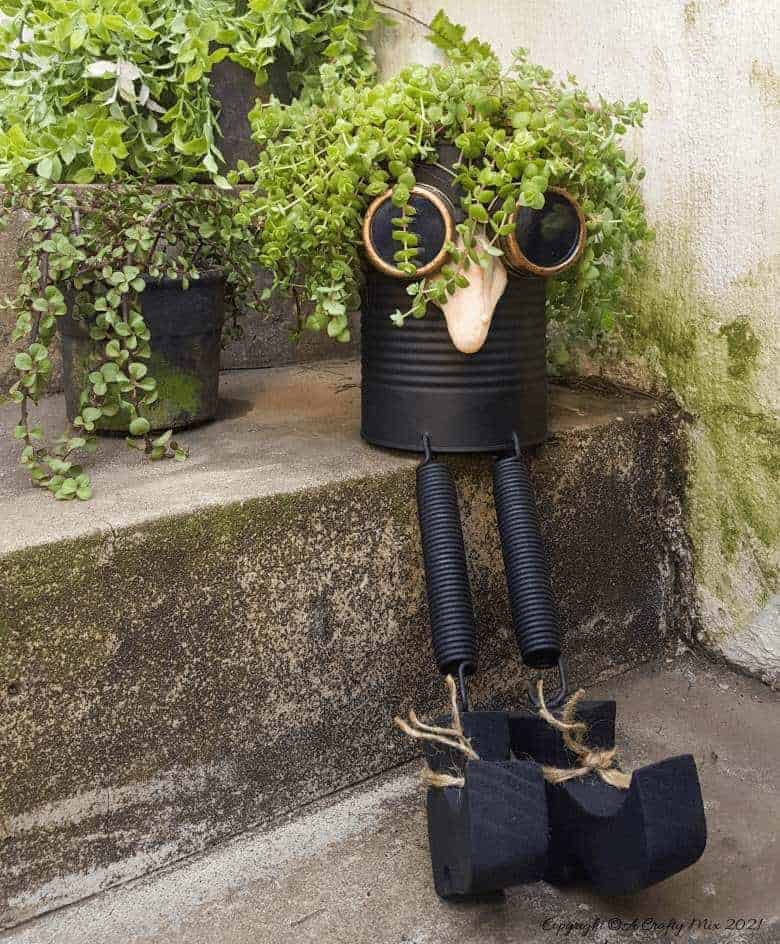Looking for a creative way to repurpose a tin can? The you'll love this tin can steampunk planter. We call him Dr Edinose and he's sure to add a little whimsy to your outdoor decor. #steampunkplanter #ACraftyMix #TinCanRecycle