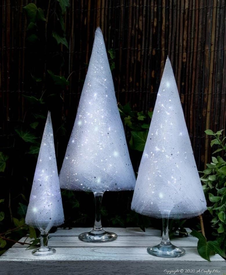 These budget-friendly wine glass Christmas trees are sure to brighten up your festive decor. #ChristmasDIY #ChristmasTree #ACraftyMix #ChristmasCrafts #TableDecor #WineGlassRepurpose