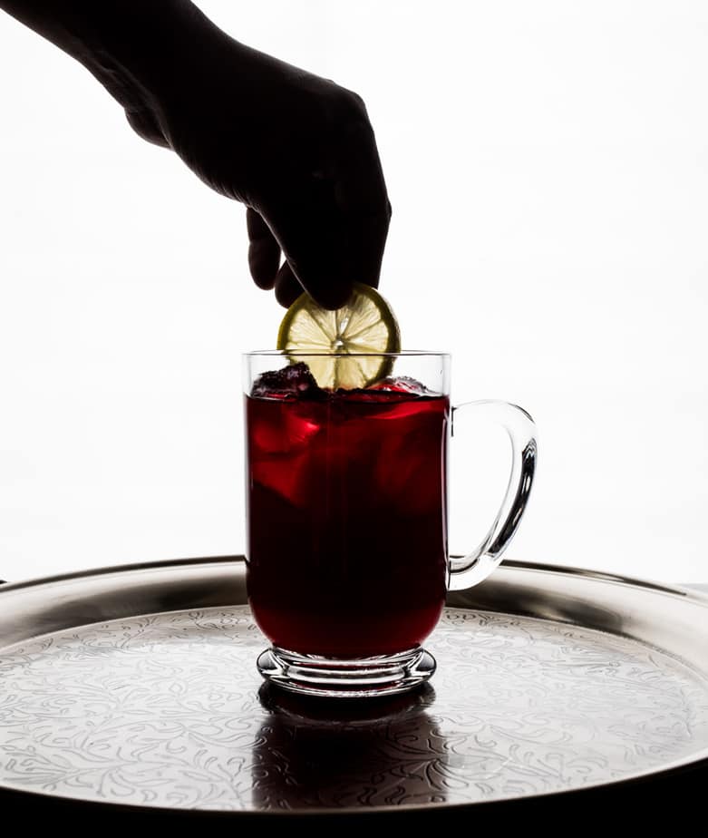 cranberry based cocktail with a Lemon Slice 