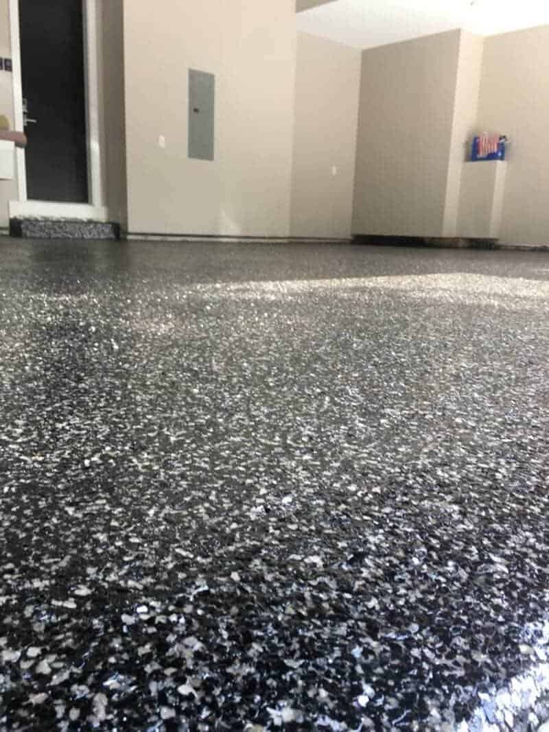 Polished epoxy garage floor with decorative flakes, installed by expert concrete contractors in Minnesota for a durable and stylish finish.