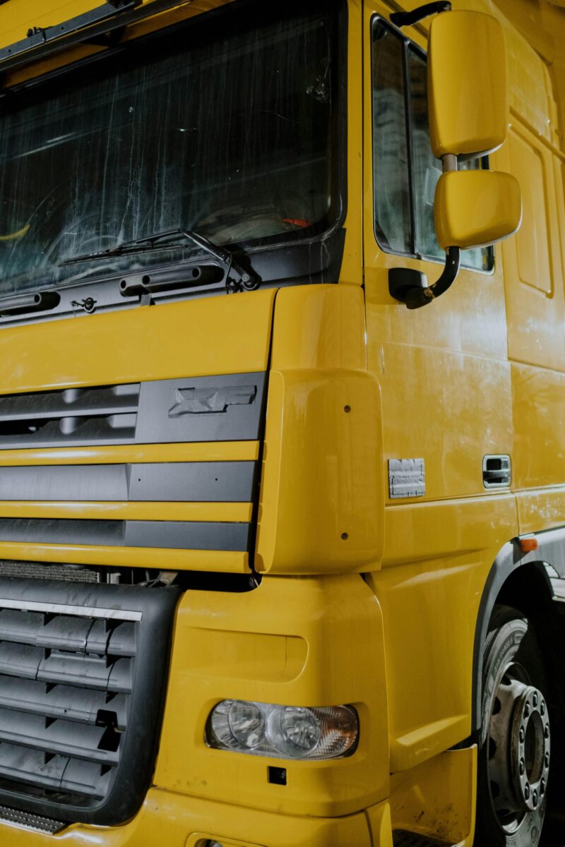 Detailed close-up of a truck parked indoors, showcasing its design and structure.