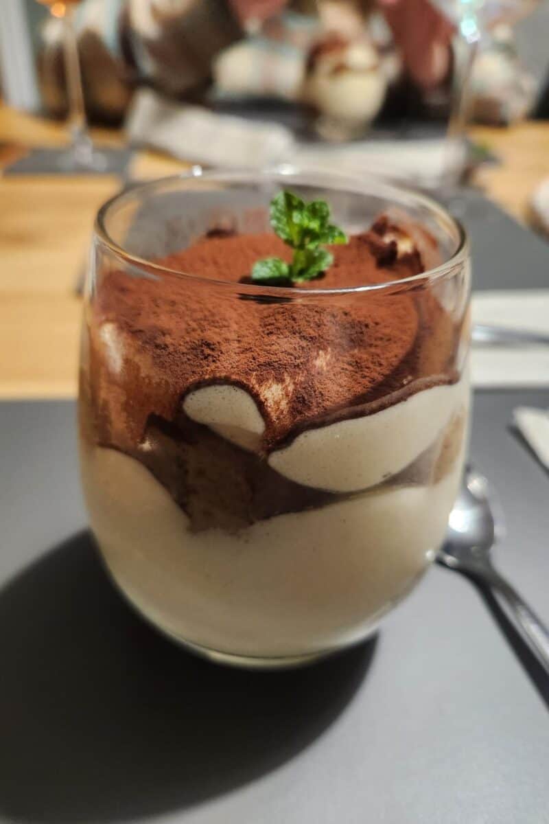 Tiramisu in a tumbler glass.