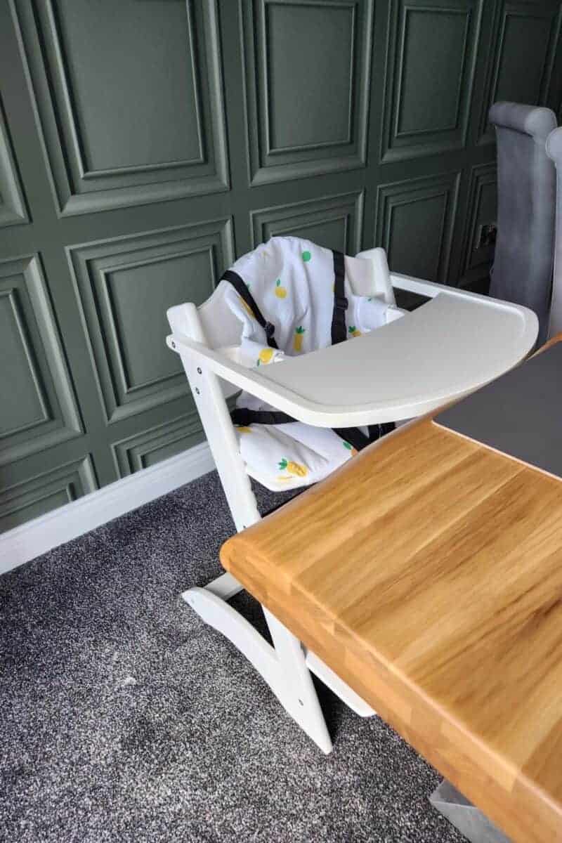 white highchair next to a table.
