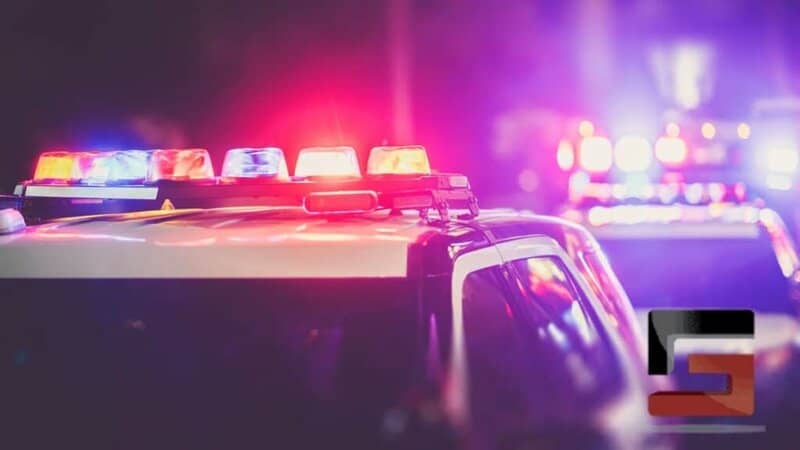 A blurred image of police cars with flashing red and blue lights at night, conveying the urgency and seriousness of legal situations. Grano Law Offices, P.C. is available 24/7 to provide legal assistance.