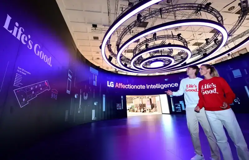 Futuristic custom island trade show booth with illuminated circular overhead rings and open entrances