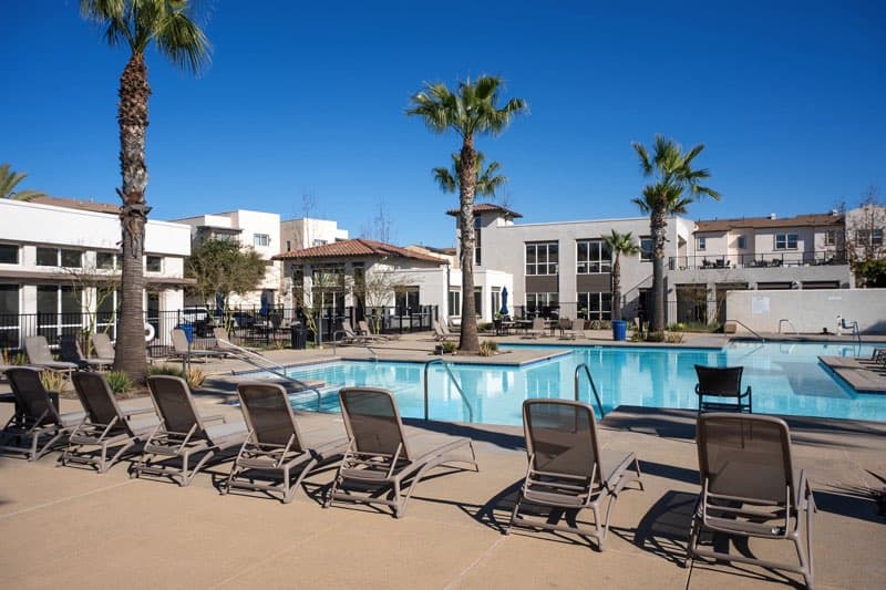 Wide-angle view of the resort-style pool and spa area at the Playa Del Sol recreation center