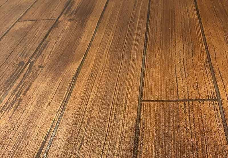 Stamped concrete flooring with a wood grain finish, showcasing durable and stylish design for indoor and outdoor spaces by a Minnesota concrete contractor.