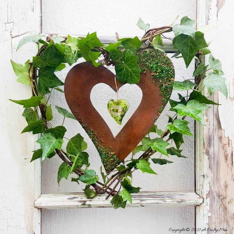 Celebrate the arrival of the most beautiful season of all and make this gorgeous Spring heart wreath. All that luscious greenery promises that the cold, miserable days of winter are almost over and that Spring is on her way, bursting with life and new growth. #SpringWreath #HeartWreath # ACraftyMix #DIYWreath #FreshIvy
