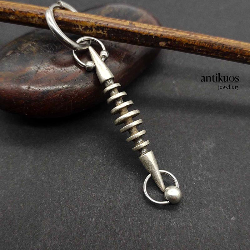 Time traveler, futuristic earring torpedo alternative earring by Antikuos jewellery, close-up