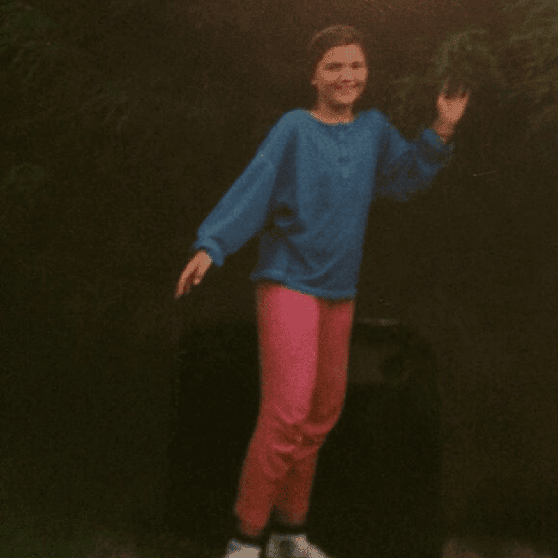 Jen aged 10 wearing pink leggings and a blue long sleeved tshirt.