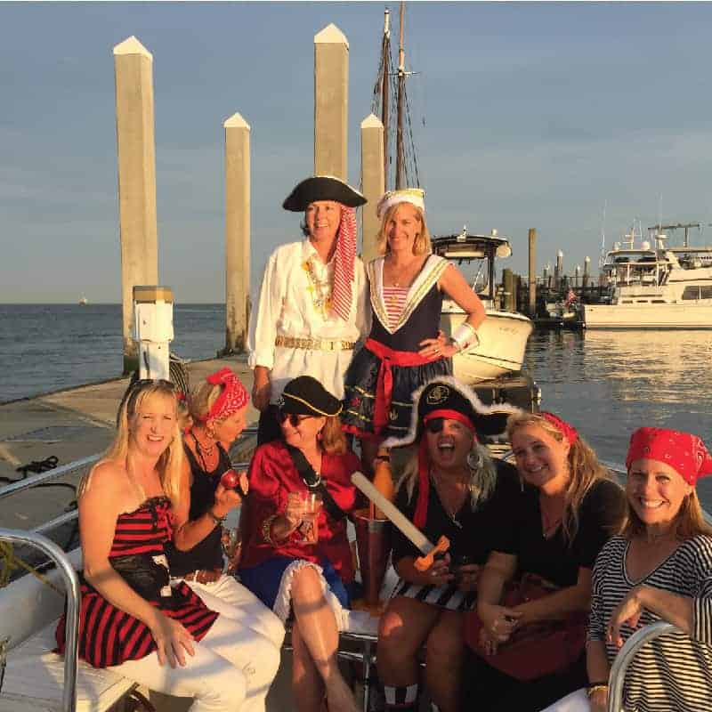 Group of women dressed up as pirates smiling and laughing. Best boat tours in Charleston, SC