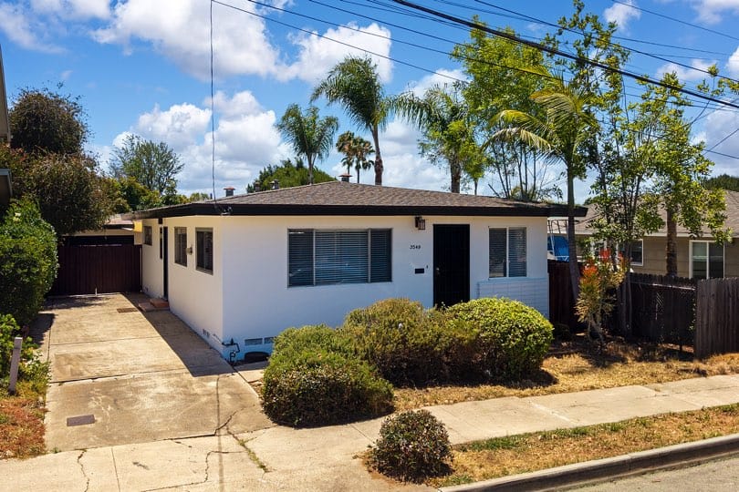 north park mid century home with exterior white walls and black trim