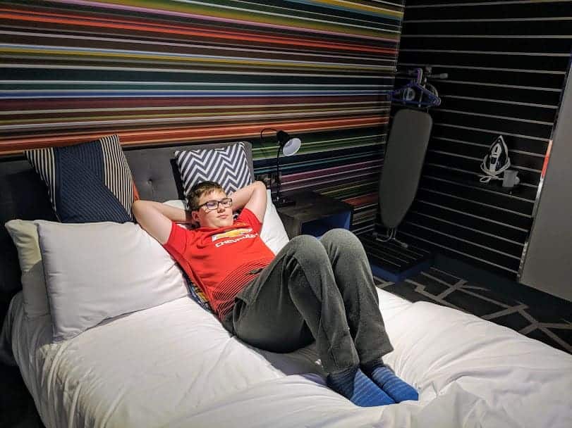 Ben relaxing on a bed at village hotel portsmouth