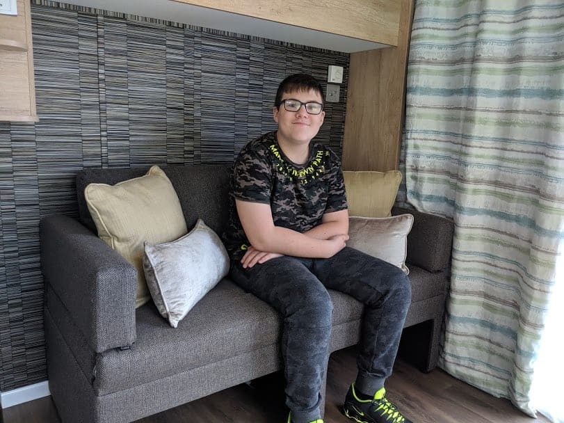Teenage boy sitting on the sofa in the pod
