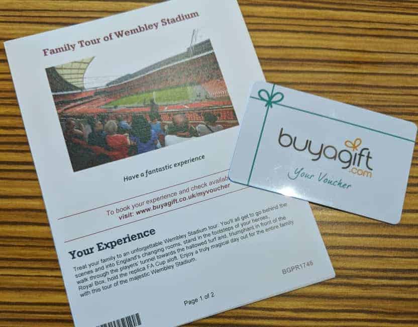 BuyAGift voucher and letter on wooden table