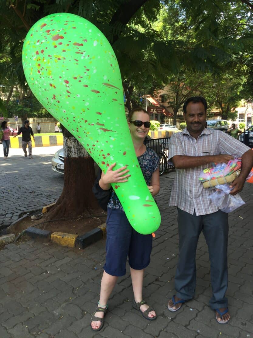 Giant Balloon Seller in Coloba Mumbai Tanya holding giant green balloon next to giant balloon Seller in Mumbai