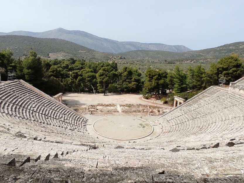 Epidaurus Amphitheatre Epidaurus Amphitheatre with green trees and mountains in the background.