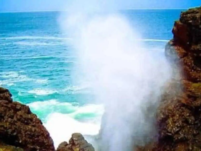 Blow Hole Hummanaya Blow Hole Hummanaya with water spraying up in between the holes walls with blue sea and sky in the background.