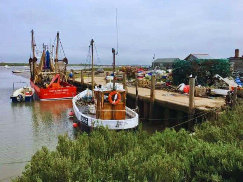 Brancaster Staithe in Norfolk, England. Brancaster Staithe in Norfolk, England. Image of fishing boats in the harbour.