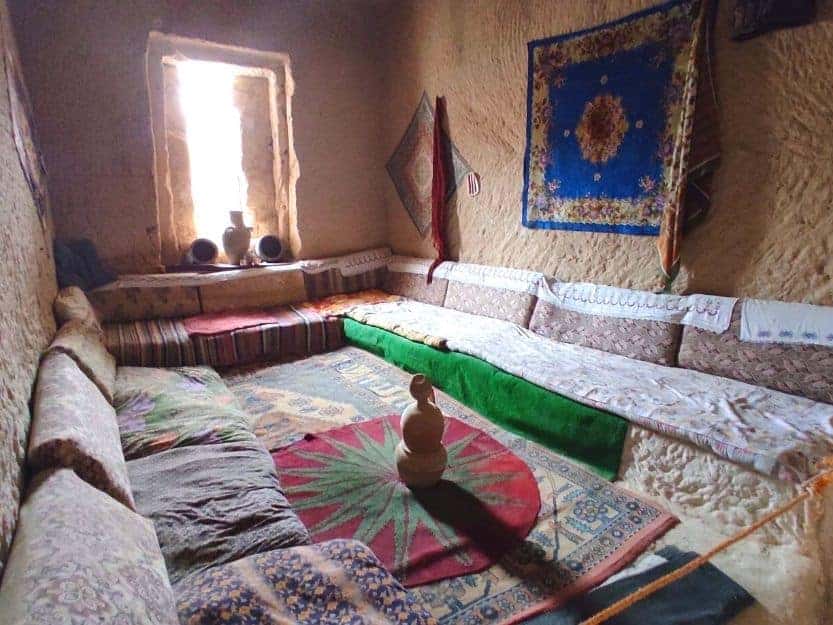 Historical Cave House in Cavusin Village Inside of historical cave house in Cavusin village full of colourful rugs and cushions