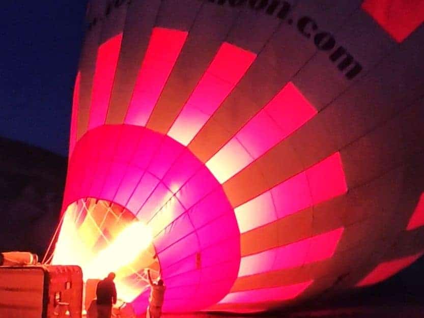 Royal Balloons Cappadocia Red and Black Hot Air Balloon Royal Balloons Cappadocia Red and Black Hot Air Balloon, with the gas burner lit up in the dark