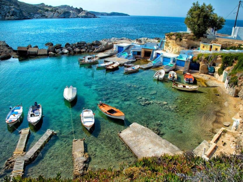 Mandrakia Bay in Milos, Greece Mandrakia Bay in Milos, Fishing boats in a little bay with rocky shore on the left