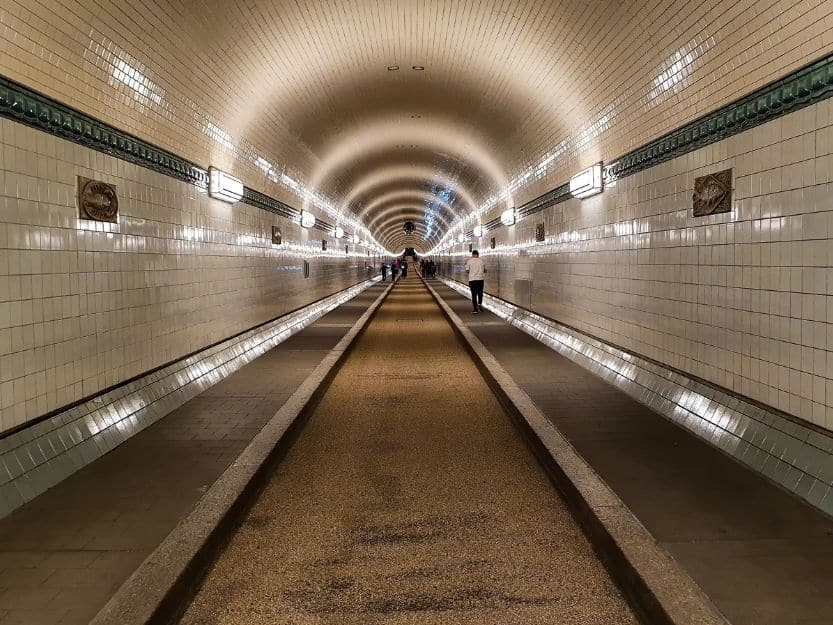 Old Elbe Tunnel in Hamburg, Germany Old Elbe Tunnel in Hamburg, Germany. White gloss tiled tunnel with a few people walking in the distance.