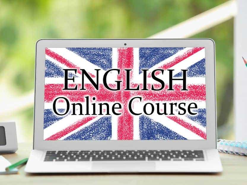 Onloine English Teaching Online English Teaching, Image of a silver laptop screen with the red, white and blue Union Jack Flag with a blurred green background.