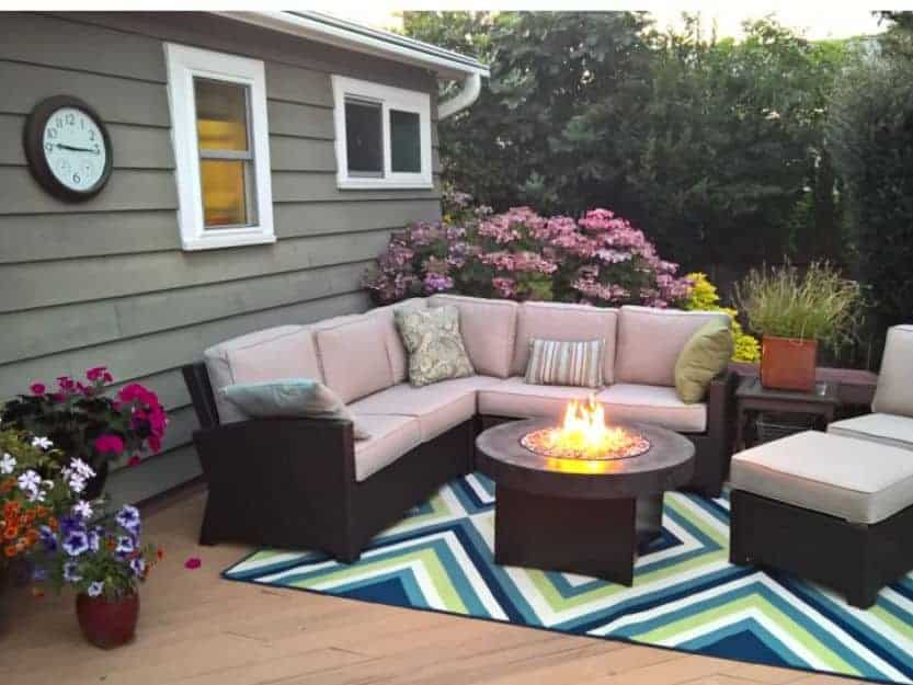 Work from Anywhere With Noad Exchange Work from anywhere with Noad Exchange,cosy outdoor sofa around a firre pit with a colourful zig zag blue and green patterned rug underneath.
