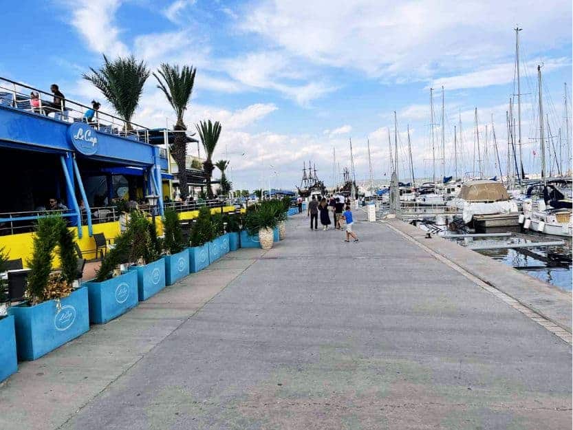 Yasmine Hammamet Marina with boats on the right and restaurants on the left
