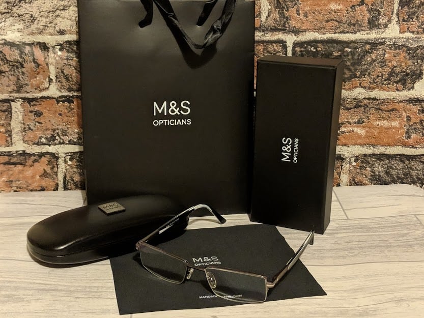 Black M&S bags with glasses in the foreground