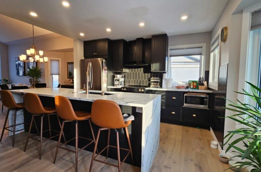 Modern Calgary kitchen renovation with [white shaker cabinets, quartz island, black hardware]