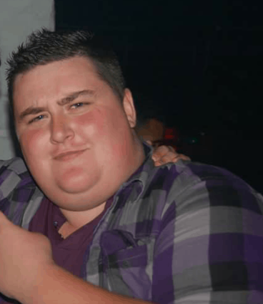Man in checked shirt looking at camera