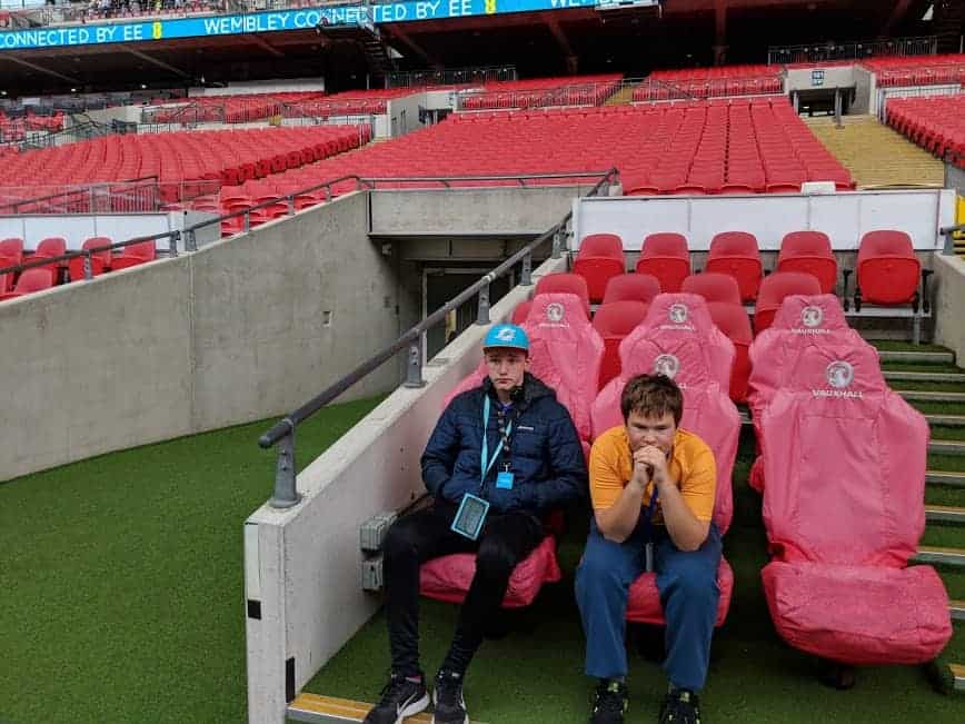 Two kids sitting in seats at Wembley Stadium