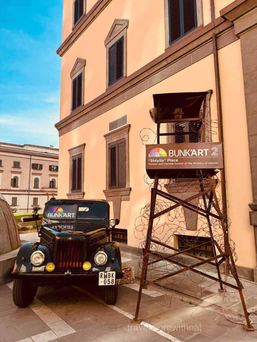 An army vehicle and checkpoint seat outside the Bunk'Art2 museum in Tirana. This is a must-see on any walking adventure in Tirana during a short visit.