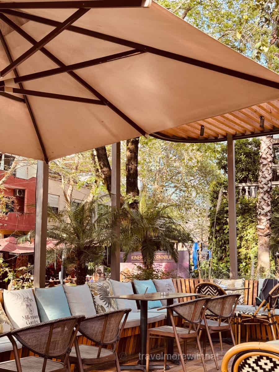 The outdoor seating space at Millennium Garden is aesthetic and a pretty stop on your self guided Tirana walking tour.