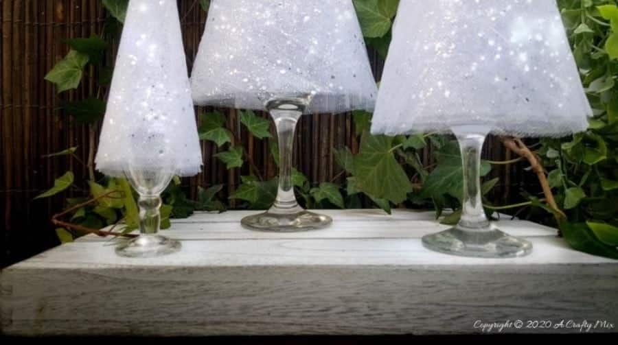 These budget-friendly wine glass Christmas trees are sure to brighten up your festive decor. #ChristmasDIY #ChristmasTree #ACraftyMix #ChristmasCrafts #TableDecor #WineGlassRepurpose