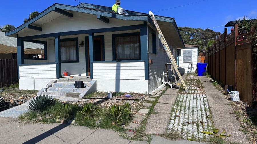 Home inspector examining the roof of a Craftsman bungalow in North Park, San Diego.