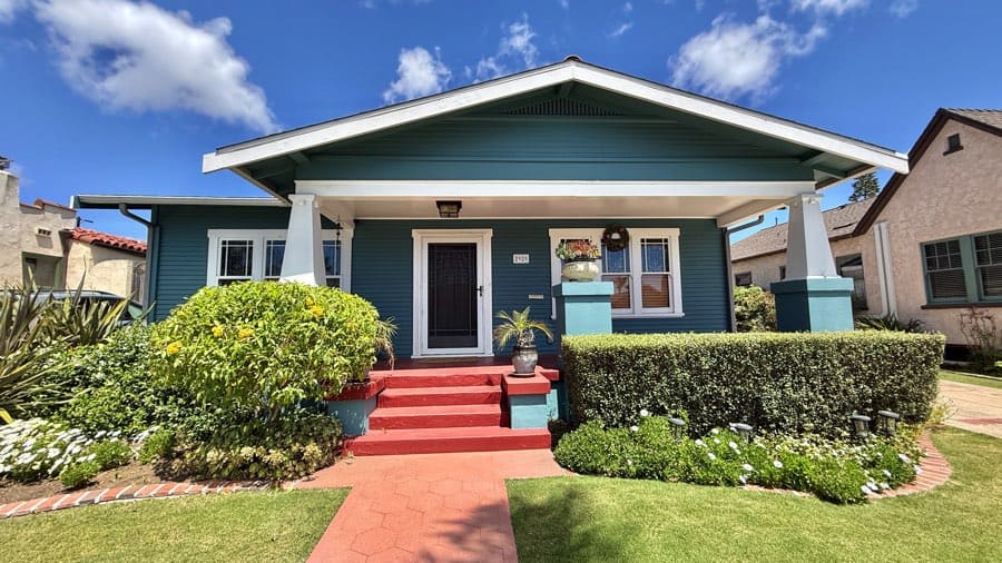 Blue Craftsman bungalow with red front steps and drought-tolerant landscaping in North Park, San Diego.