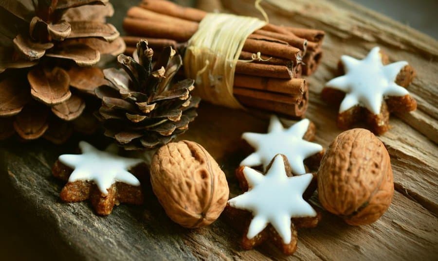 christmas season items walnuts, cinnamon sticks and stars