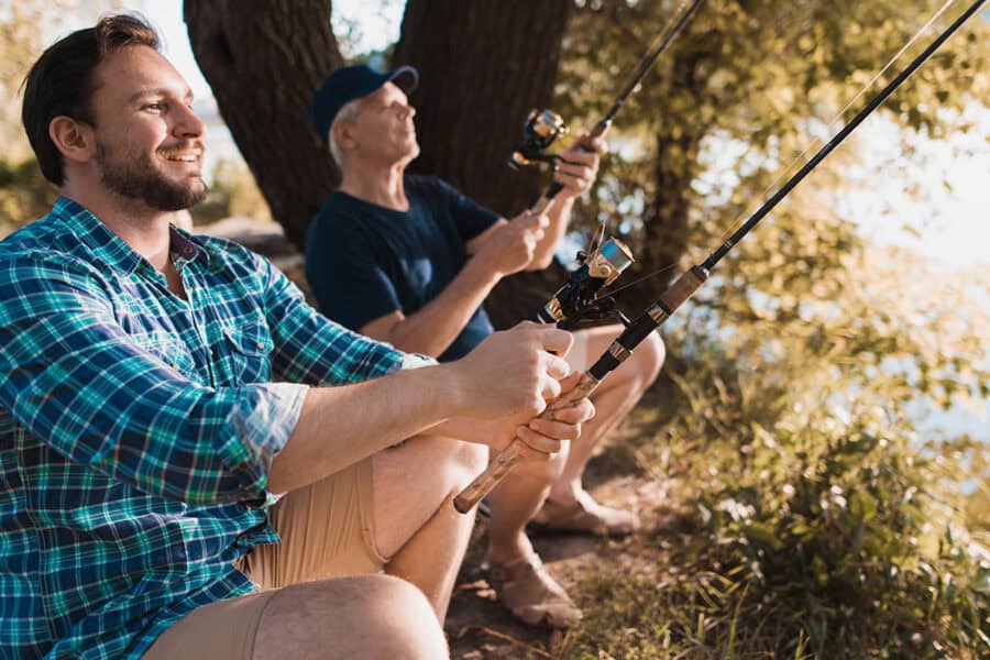 Older Father Fishing With Middle Aged Son