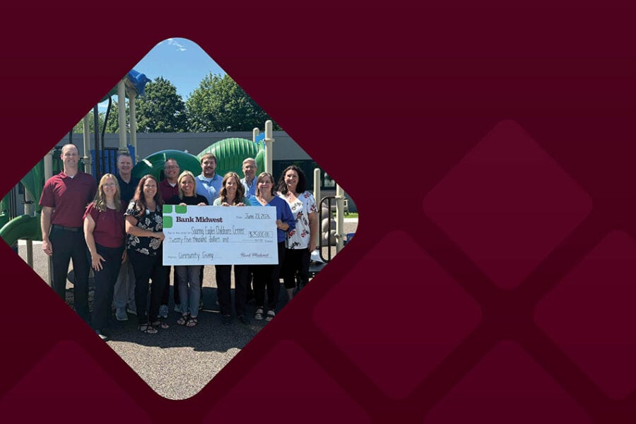 Bank Midwest employees present $25,000 check to reps for Windom Area Daycare