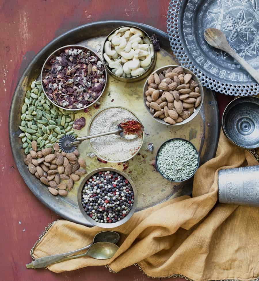 Thandai - Ingredients to make thandai - cardamom, poppy seeds, almonds and othe rnuts